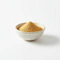 Ginger powder in a ceramic bowl on white background