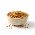 Whole mustard seeds in a ceramic bowl on white background