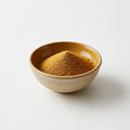 Ground cumin powder in a ceramic bowl on white background
