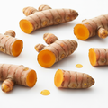 Fresh turmeric root pieces on white background