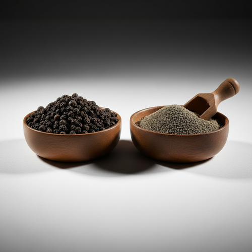 Whole black peppercorns and ground black pepper in wooden bowls on white background